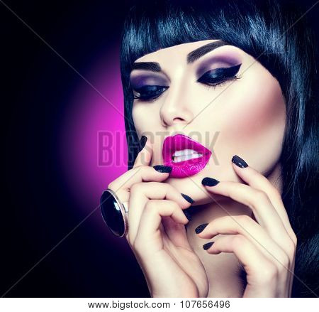 High Fashion Model Girl Portrait with Trendy fringe Hair style, Make up and Manicure. Black Hairstyle, Black Nail Polish and purple Lipstick. Woman Makeup. Sexy Lips. Bob Haircut