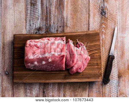 big piece of raw meat on cutting board