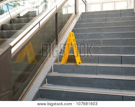 Oviedo, Spain - November 1 2015: Foldable Plastic Wet Floor Sign Stands On The Stairs Step At The Fe