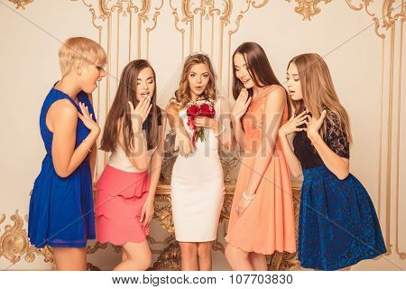 Cheerful Bride Showing Her Surprised Bridesmaids A Wedding Ring
