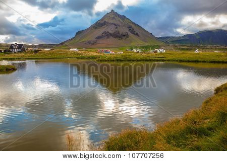 Evening light in the Polar region. Sunset in the fishing settlement of Arnastapi