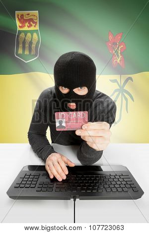 Hacker With Canadian Province Flag On Background Holding Id Card In Hand - Saskatchewan