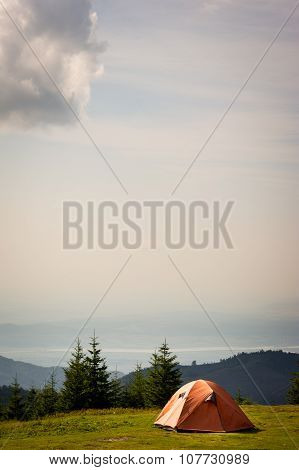 Orange tent in the mountains