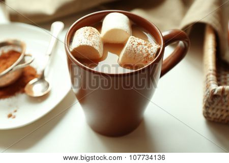Cup of coffee with marsh mellow on a table