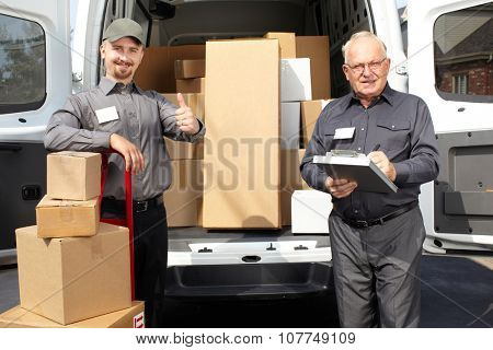 Group of delivery men with parcels near shipping truck. Parcel service.