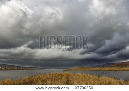 dark clouds river island.