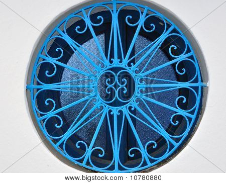 Round Window With A Blue Grid
