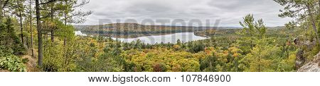 Panorama Looking Out Over A Lake Surrounded By Forest In Autumn