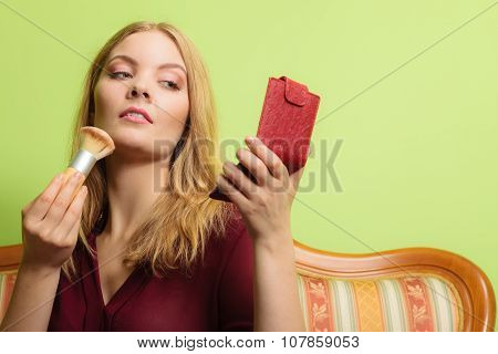 Attractive Woman Applying Make Up With Brush.