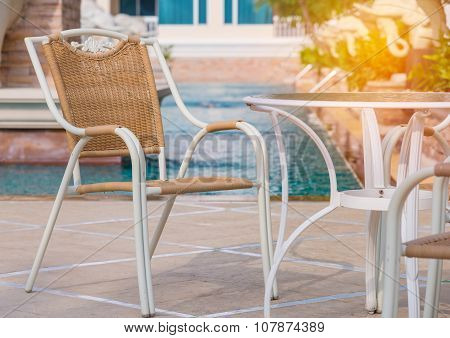 Chairs And Tables Next To Swimming Pool
