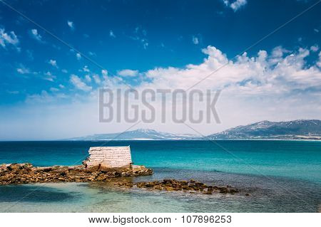 Ancient marine fortifications. Ruins of old tower into Mediterra