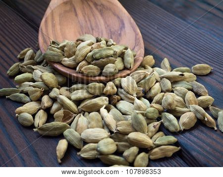 Green Cardamom Pods On The Dark Wooden Textured Planks