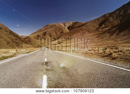 Continuous Road in a Scenic with Mountain Ranges Afar Concept