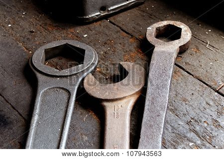 Three Old Wrech Laying On An Worn Wooden Table