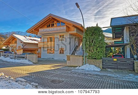 GARMISCH-PARTENKIRCHEN GERMANY - JANUARY 06 2015: Street with residential houses in Garmisch-Partenkirchen. It is a mountain resort town in Bavaria southern Germany in the heart of the Alps