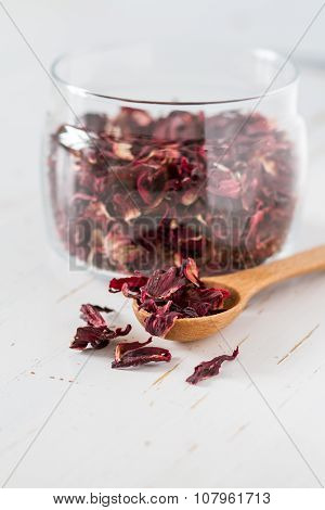 Dry karkade tea, white wood background