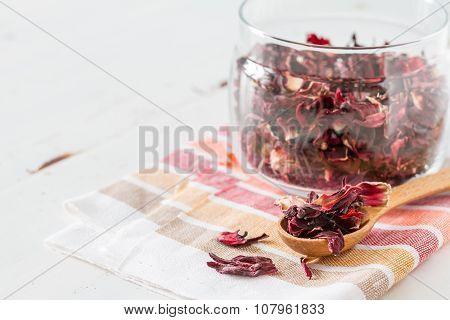 Dry karkade tea, white wood background