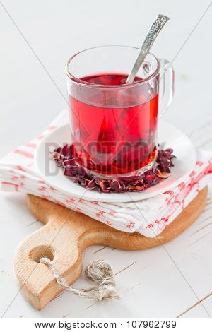 Karkade tea on white wood background