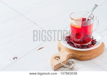 Karkade tea on white wood background