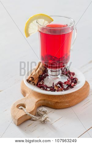 Karkade tea on white wood background