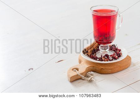 Karkade tea on white wood background