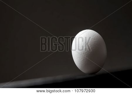 The Egg Is Upside Down On A Wooden Tilted Table