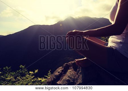 young yoga woman on sunrise mountian peak