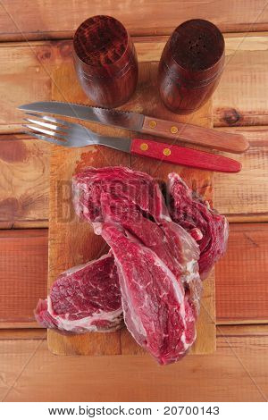 savory: uncooked raw bloody beef meat steak before cooking on wood