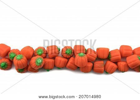 Candy Pumpkins in Row on Isolated White Background