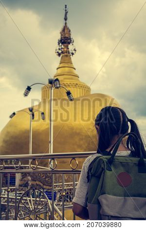 Tourist girl entering to golden rock pagoda at sirey temple phuket thailand.
