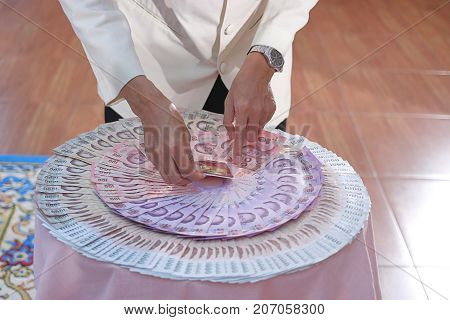 Wedding ring and bride's price or dowry in Thai wedding ceremony. Selective focus and shallow depth of field.