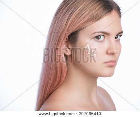 Young pretty girl with foundation on her face