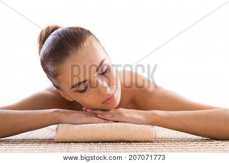 Young, beautiful and healthy woman relaxing in spa salon. Traditional oriental therapy and massaging treatments.