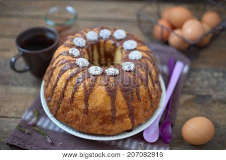 Bundt Cake with Chocolate Fudge Glaze and Chocolate dots circle candy nonpareils with colorful sprinkles on top 