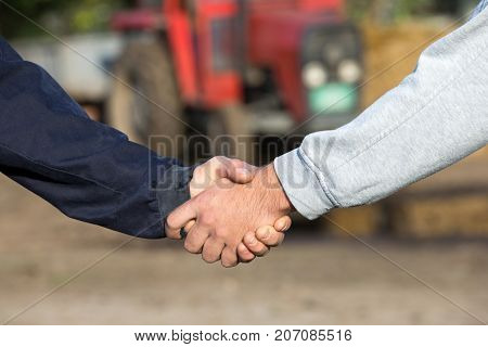 Farmers Shaking Hands On Farm