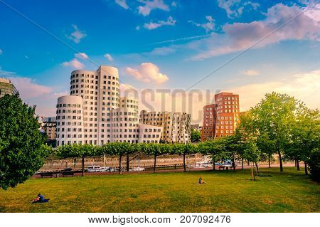 Looking at Media Harbor at Rhine-River in Dusseldorf in Germany. Media Harbor skyline among greenery of the city. Beautiful and colorful cityscape