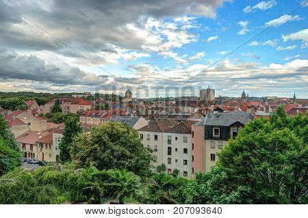 Aerial view of old town of Metz, beautiful french city. Greenery of the city park in front of the multiple facedes of old buildings.