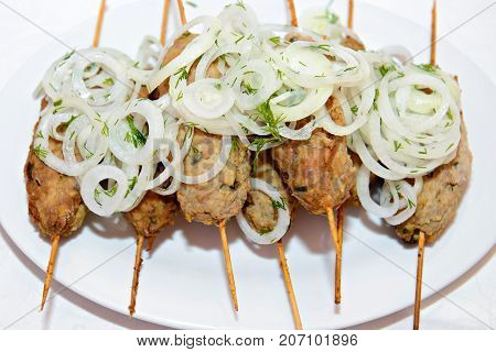 Kebab is a meat dish, common in the Caucasus, Central Asia and Turkey. Minced meat of minced lamb threaded on a skewer and roasted on the grill with onions.