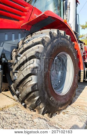 Samara Russia - September 23 2017: Big wheel of new modern agricultural tractor Kirovets K 4 on display at the annual Volga agro-industrial exhibition
