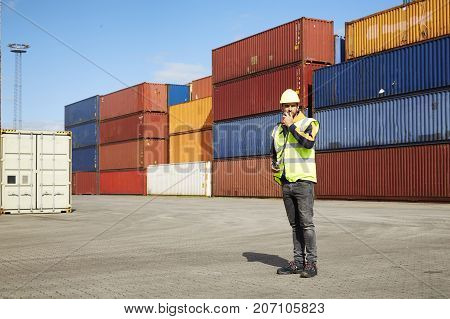 Docker dude in shipyard with cargo containers