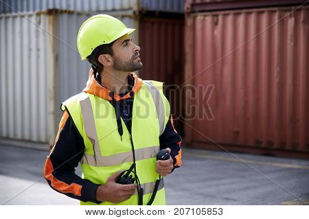 Docker guy working in shipyard looking away