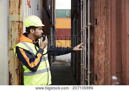 Docker using walkie talkie at dockyard to discuss container