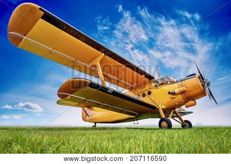historic biplane a against a cloudy sky