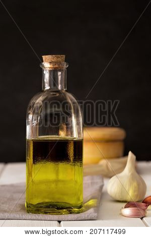 Olive oil and vegetables on the black background
