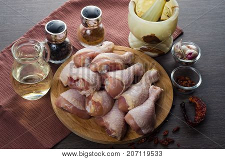 Fresh raw chicken legs arrangement on a kitchen cutting board