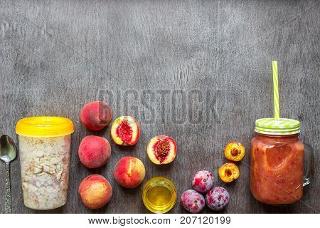 Fruit Smoothies. Peach and plum smoothie. Peach, plum and oatmeal. Delicious and healthy breakfast on wooden background. Top view. Copy space. Still life. Flat lay