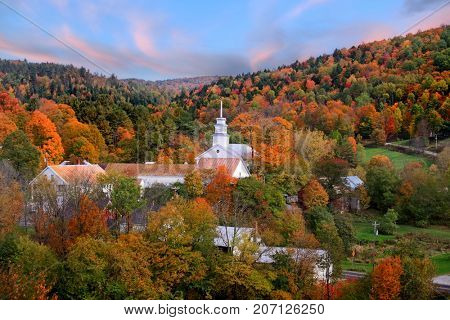 Small church in Topsham village in Vermont in the middle of fall foliage