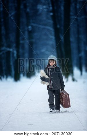 Sad Child, Boy, Walking In A Forest With Old Suitcase And Teddy Bear