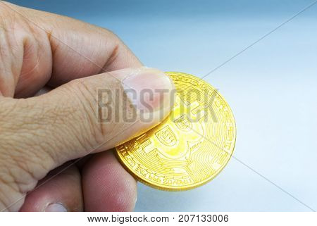 Golden ฺBitcoin in hand With white background