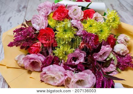 A Beautiful Bouquet Of Pink Eustoms, A Yellow Chrysanthemum, A Red And Pink Rose, On Shabby White Wo